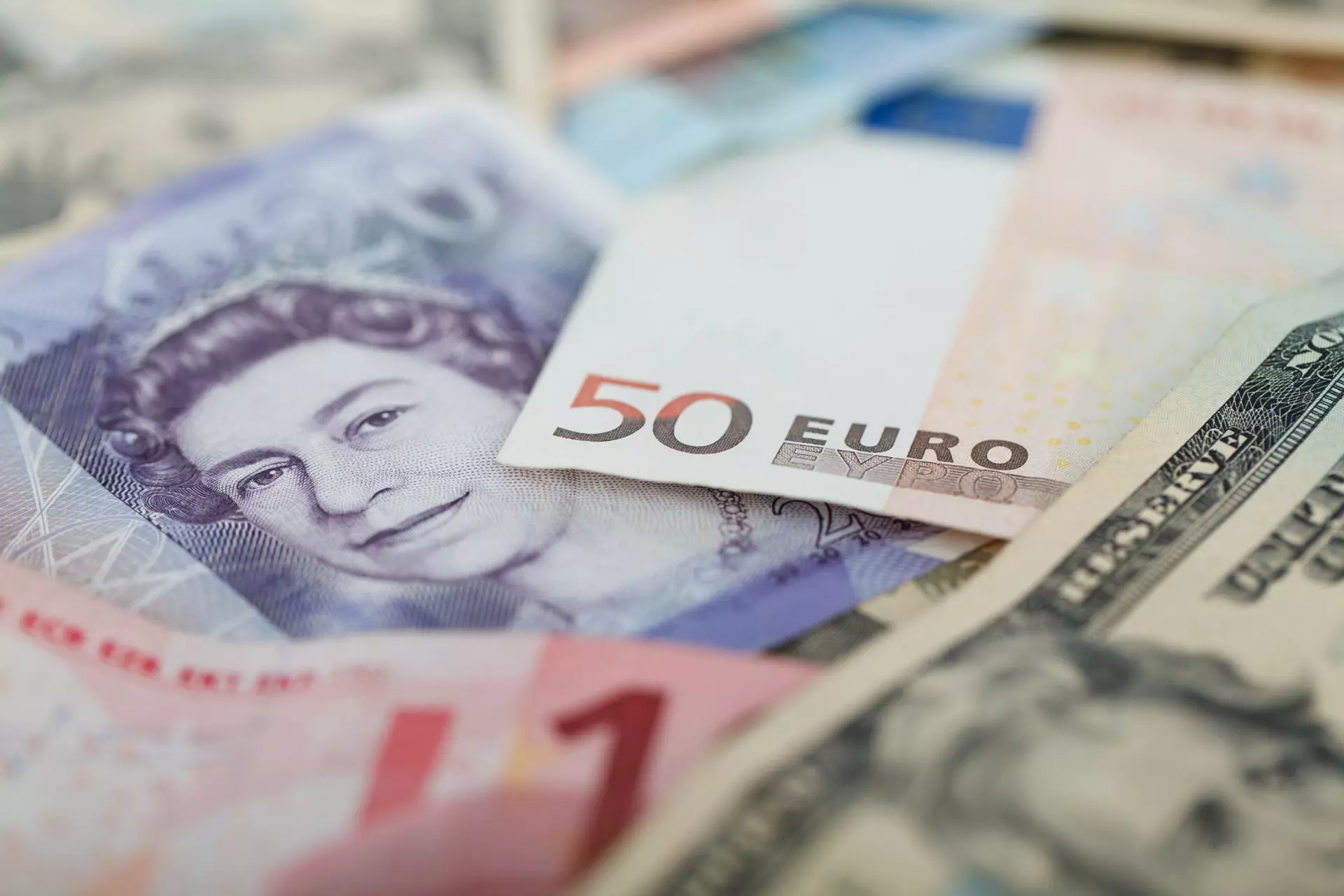 A pile of banknotes containing euros, pounds and dollars