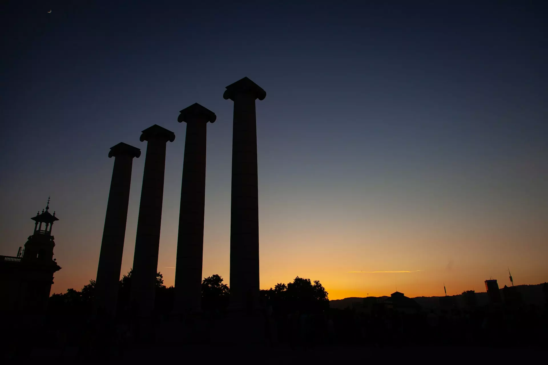 Ancient columns silhouetted against a sunset