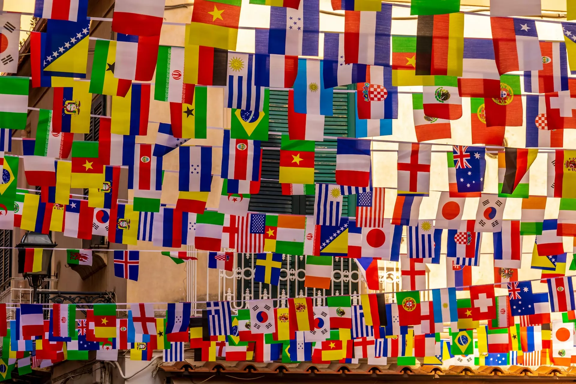 A multitude of International flags hanging from bunting