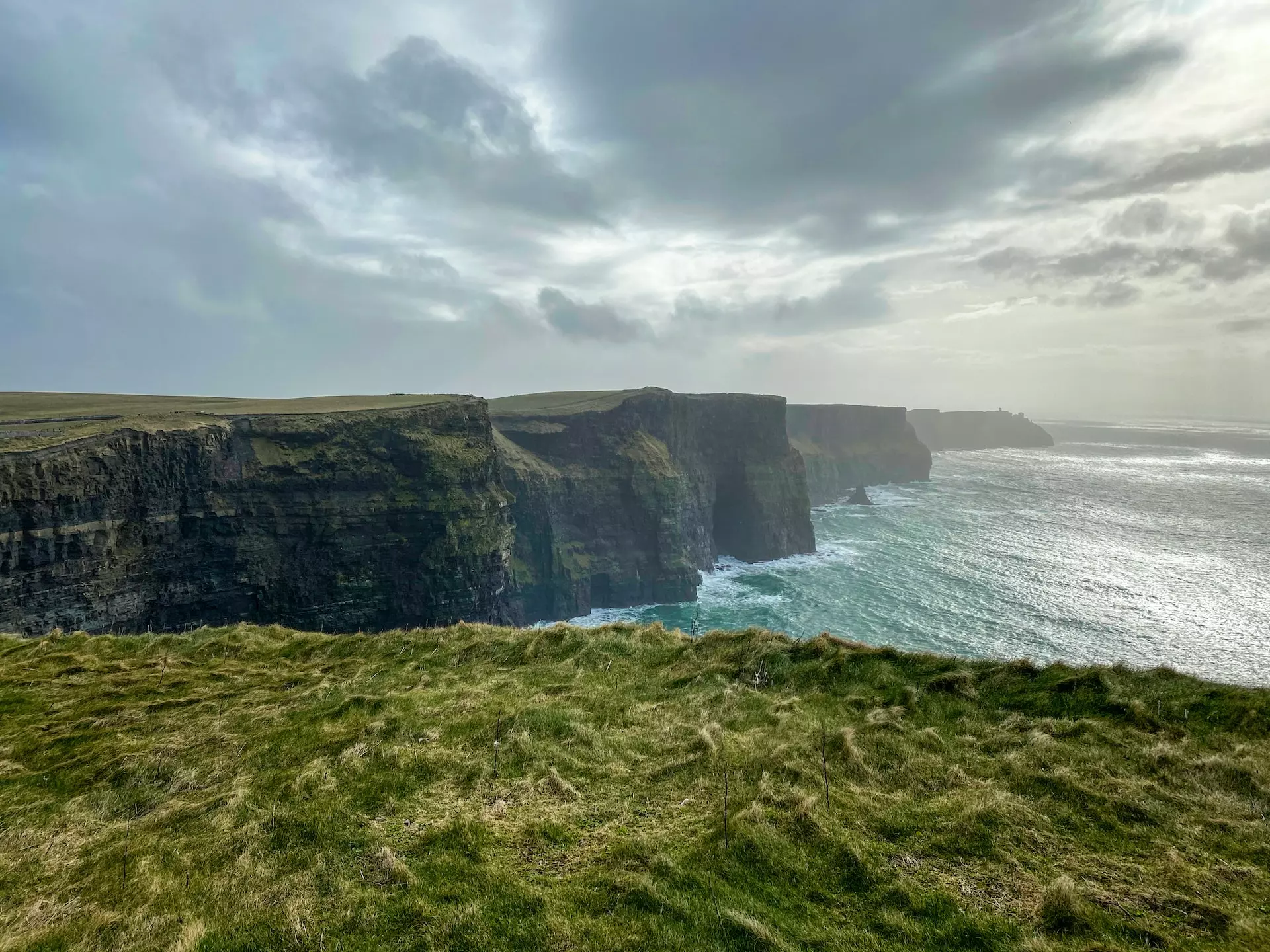 Steep sea cliffs with rough seas breaking against them