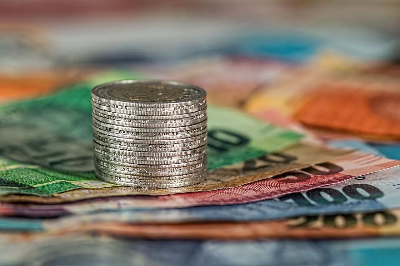 A pile of coins on top of banknotes